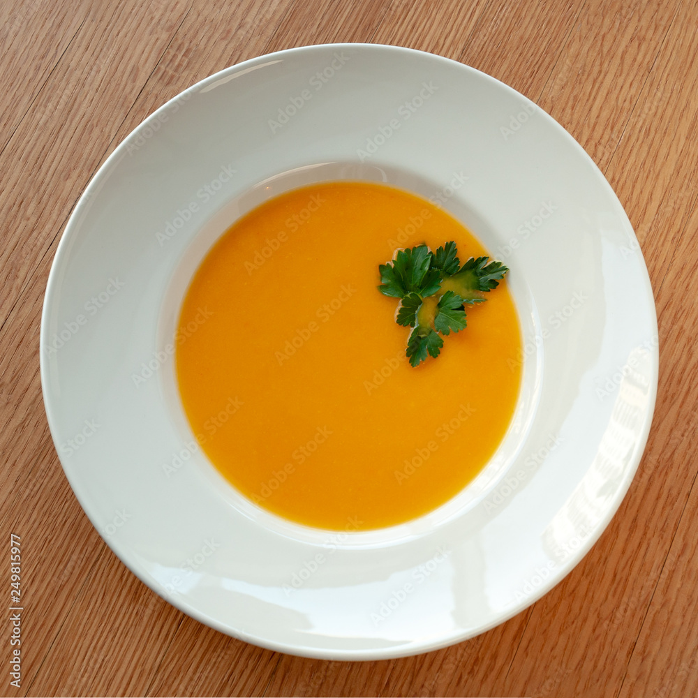 Pumpkin curry soup decorated with herbs and croutons. Pumpkin curry soup decorated with herbs and croutons.