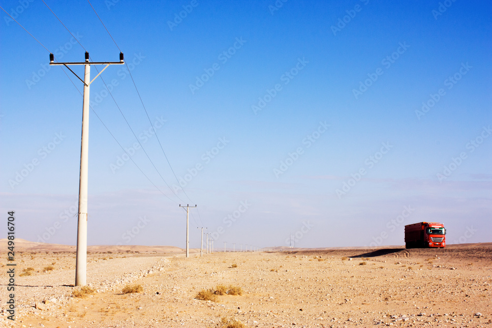 custom made wallpaper toronto digitalElectric power poles in desert of Jordan. High voltage powerlines. Early morning in wilderness after sunrise. Red truck on road.