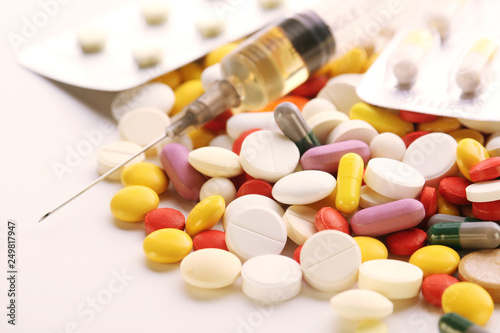 Medication pills and a sirynge as a medical healthcare concept	 photo