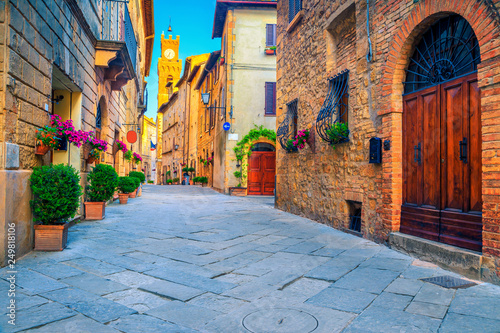 Rustic brick and stone houses decorated with colorful flowers, Italy © janoka82