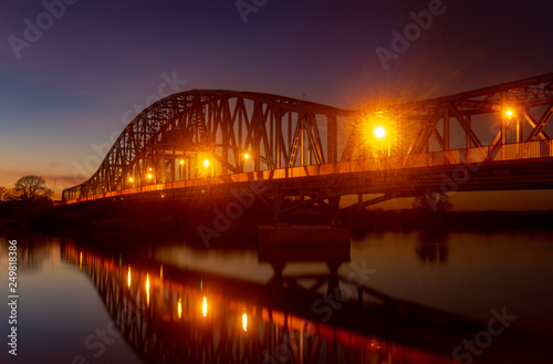 iron truss bridge at sunset