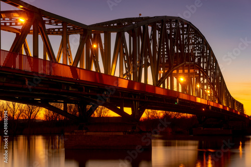 iron truss bridge at sunset