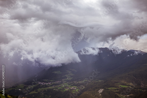 Thunderstorm mood in the mountains. Big cloud formation over a mountain. Tyrol Italy