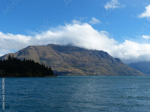 photo picture of a beautiful sea and ocean view with a natural background of rocks, forests and mountains © IGOR