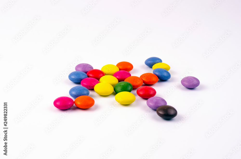 Multicolored chocolate sweets on a white background Multicolored chocolate sweets on a white background
