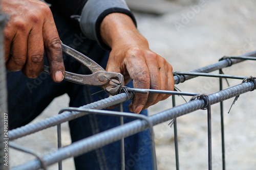 Construction technicians are working on steel, concrete building structures.