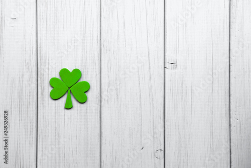 Happy St Patrick's Day. Decorations in form of shamrock leaves on a gray wooden background