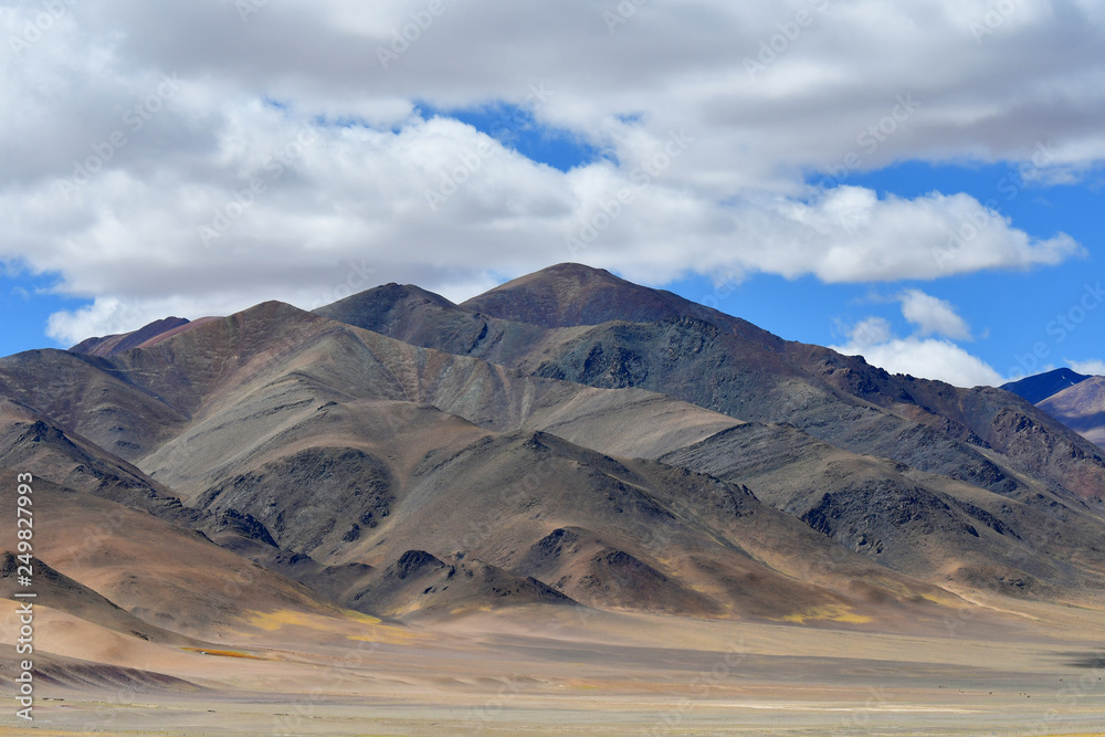 China, Tibetan plateau. Big clouds over the TRANS-Himalayas on the way from Ringtor to Yakra in June in sunny day