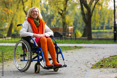 happy young adult woman on wheelchair