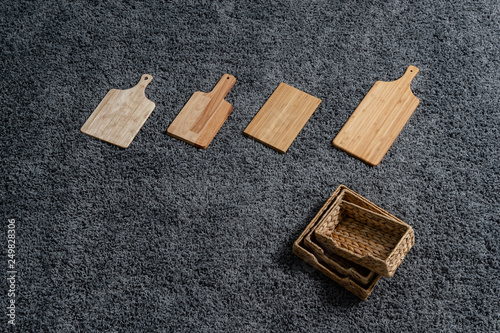 Various kinds of kitchen tools on the grey carpet.