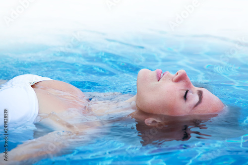Girl relaxing in swimming pool photo