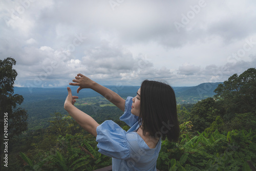 Happy young cute Asian Japanese girl hipster backpack photography women taking a photo at beautiful sky mountains scenery views 