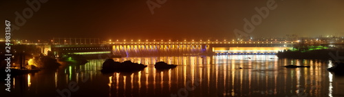 Night view of the dam of the hydroelectric station named after V. I. Lenin on the Dnieper River. Ukraine, Zaporozhye.