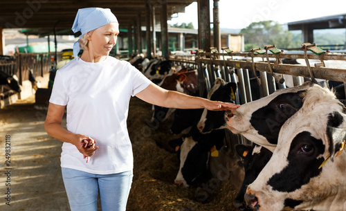 female farmer posing in cowshed