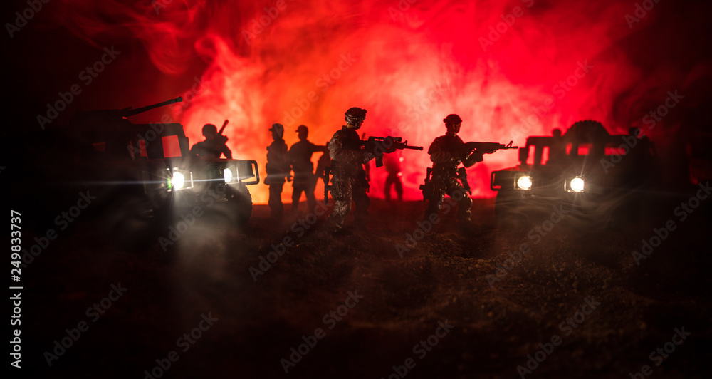 Fototapeta premium War Concept. Military silhouettes fighting scene on war fog sky background, Fighting silhouettes Below Cloudy Skyline At night. Battle scene. Army vehicle with soldiers. army
