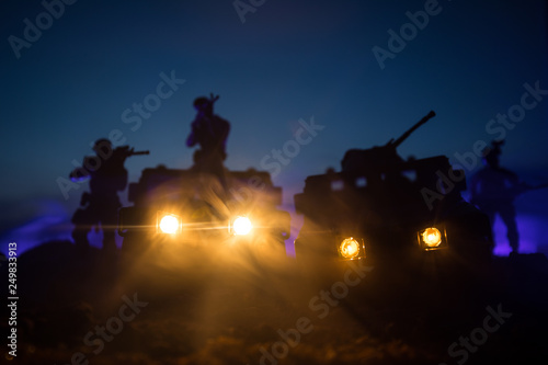 War Concept. Military silhouettes fighting scene on war fog sky background, Fighting silhouettes Below Cloudy Skyline At night. Battle scene. Army vehicle with soldiers. army