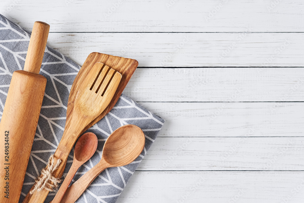 Kitchen utensils, rolling pin, spatula and towel on a white wooden background with copy space Kitchen utensils, rolling pin, spatula and towel on a white wooden background with copy space