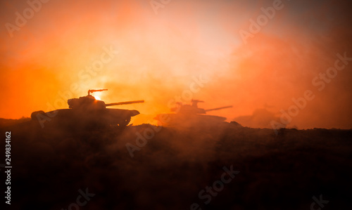 War Concept. Military silhouettes fighting scene on war fog sky background, World War Soldiers Silhouettes Below Cloudy Skyline at sunset. Attack scene. Armored vehicles.