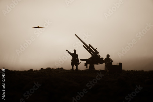 An anti-aircraft cannon and Military silhouettes fighting scene on war fog sky background. Allied air forces attacking on German positions. Artwork decorated scene.