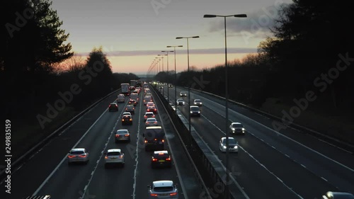 Timelapse Of Traffic On Motorway From Dark Through Sunrise To day photo