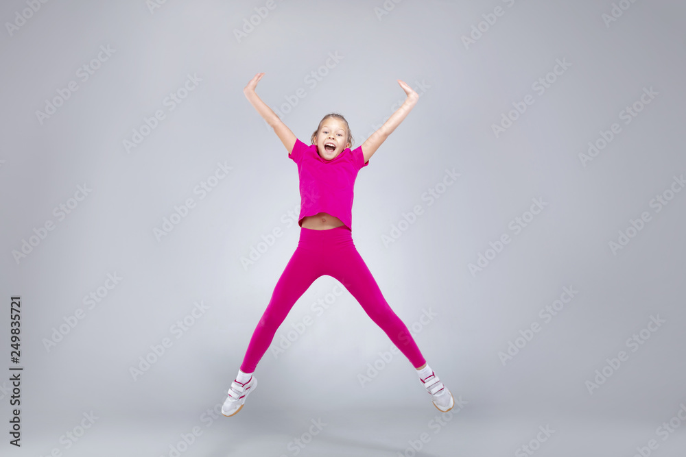 Young caucasian girl doing gym exercises in sportwear