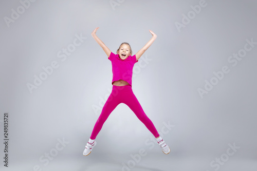 Young caucasian girl doing gym exercises in sportwear