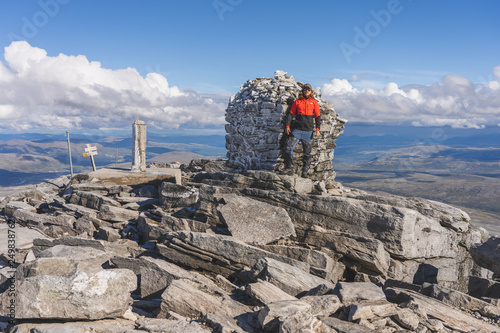 man on top of mountain photo