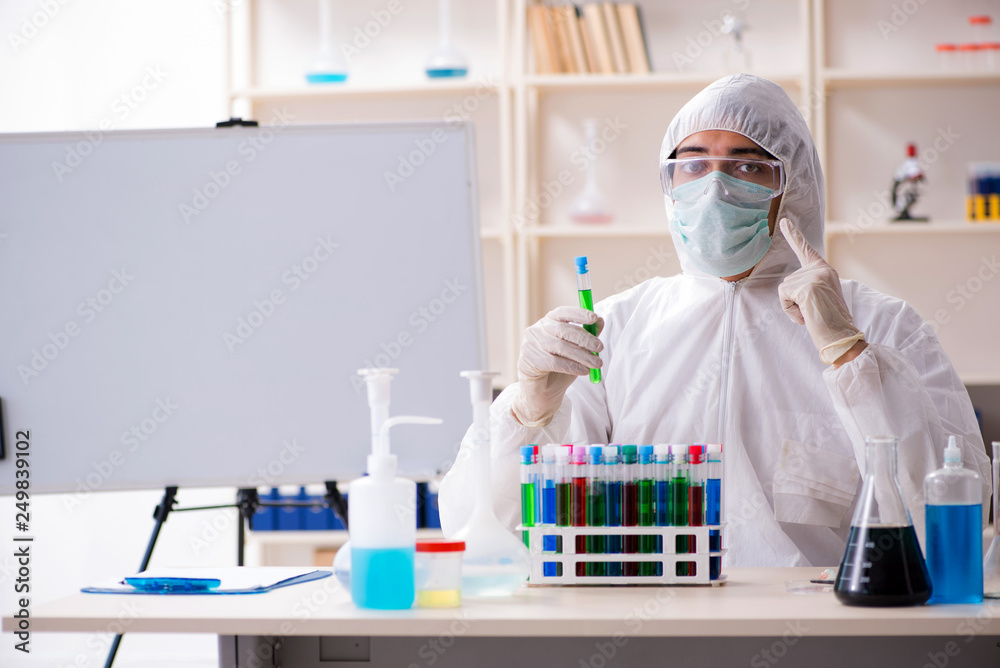 Young handsome chemist working in the lab Young handsome chemist working in the lab