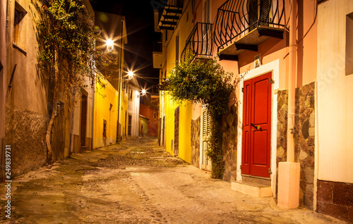 Fototapeta Naklejka Na Ścianę i Meble -  Narrow ancient streets during the evening in the little medieval town Bosa, Sardinia Island, Italy