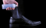 deodorant for men's shoes to get rid of unpleasant smell on a black backdrop
