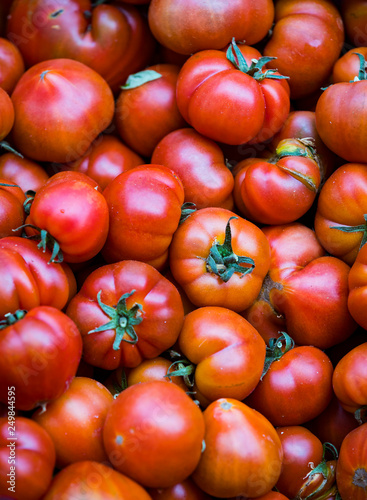 Background of ripe non-GMO tomatoes on the market in Milan in Italy.