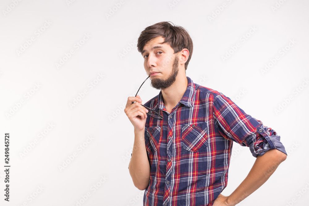 Emotions and people concept - young thoughtful man on white background with copy space Emotions and people concept - young thoughtful man on white background with copy space