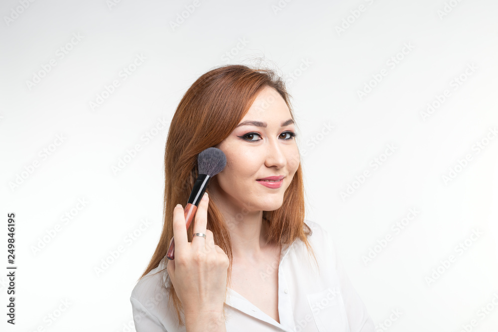 Makeup artist, beauty and cosmetics concept - Korean female make-up artist with makeup brushes on white background Makeup artist, beauty and cosmetics concept - Korean female make-up artist with makeup brushes on white background