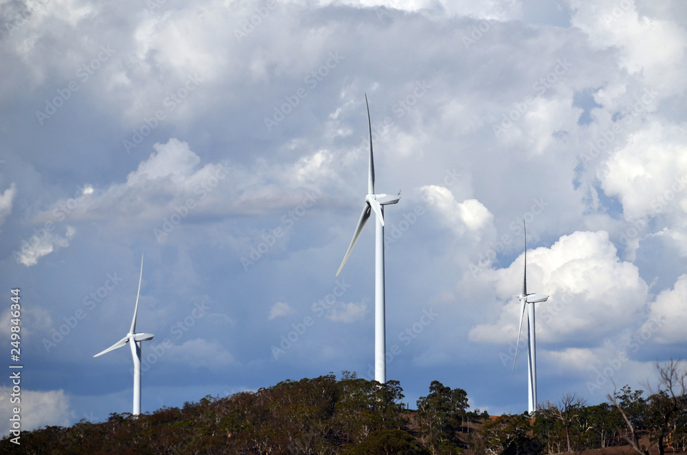 Wind turbines under a dramatic cloudy sky between Goulburn and Yass in rural New South Wales, Australia. Wind turbines under a dramatic cloudy sky between Goulburn and Yass in rural New South Wales, Australia.
