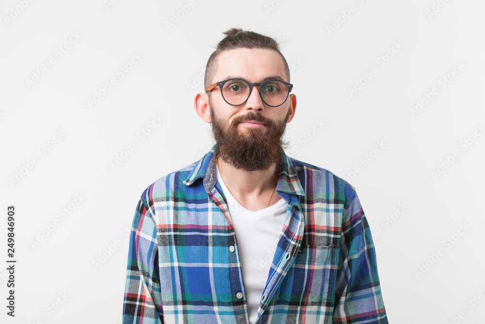 Hipster, fashion, people concept - young hipster bearded man in glasses and shirt standing over the white background Hipster, fashion, people concept - young hipster bearded man in glasses and shirt standing over the white background
