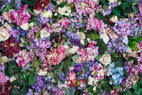 Multi-colored wallpaper of hydrangea flowers and roses.