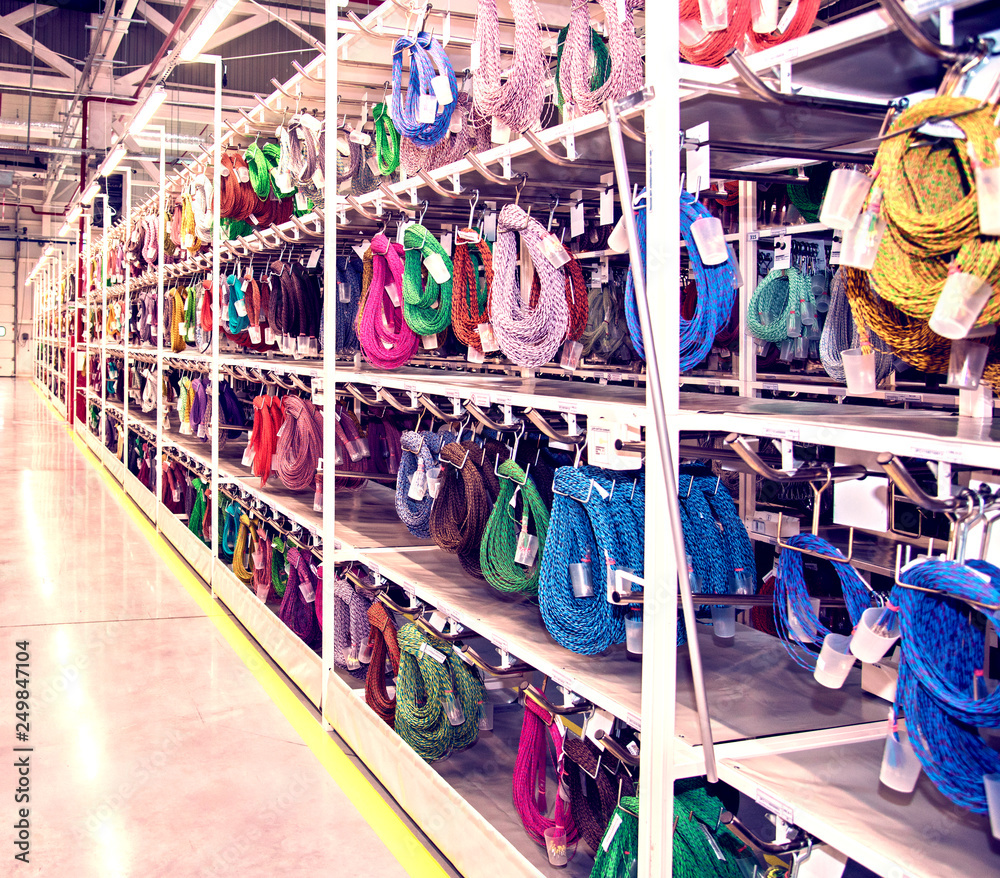Fototapeta premium Industrial landscape with stainless steel wire rope racks at a modern plant for the production of electric wiring for automobiles. Logistics