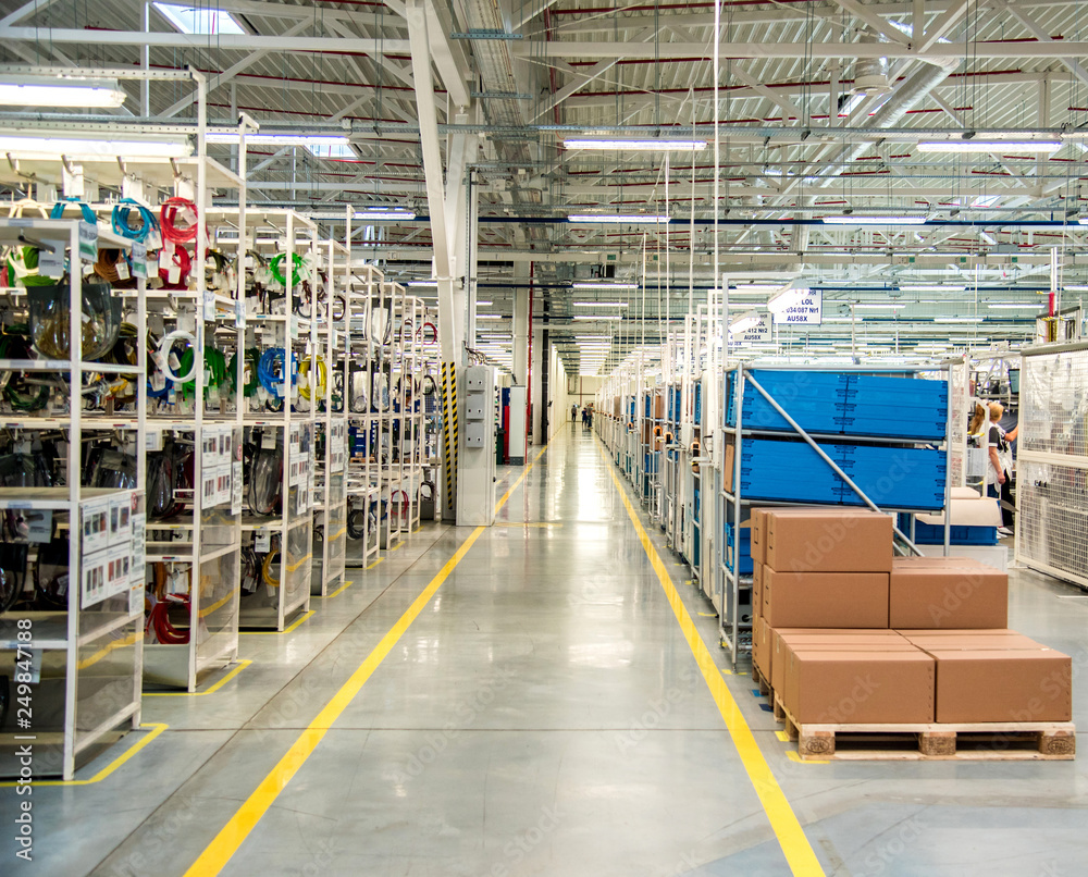 Industrial landscape with boxes and racks of wires at a modern plant for the production of electric wiring for automobiles. Logistics