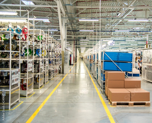 Obraz na płótnie Industrial landscape with boxes and racks of wires at a modern plant for the production of electric wiring for automobiles. Logistics w salonie