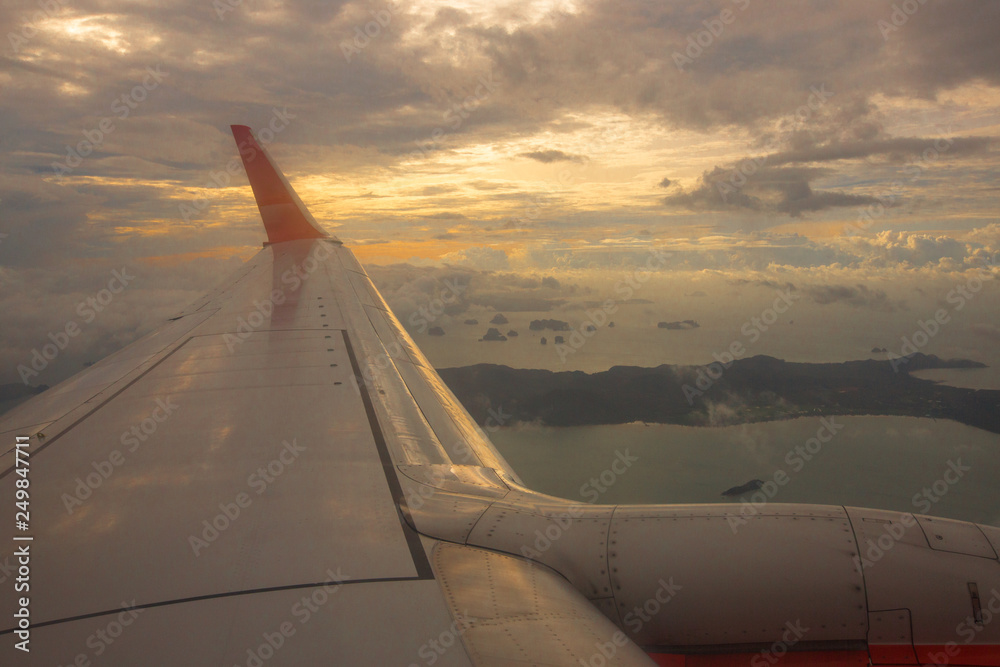 The background of the plane window view, which overlooks high-angle views (clouds, mountains, sea) is a natural beauty, is the time to travel or travel to work. The background of the plane window view, which overlooks high-angle views (clouds, mountains, sea) is a natural beauty, is the time to travel or travel to work.