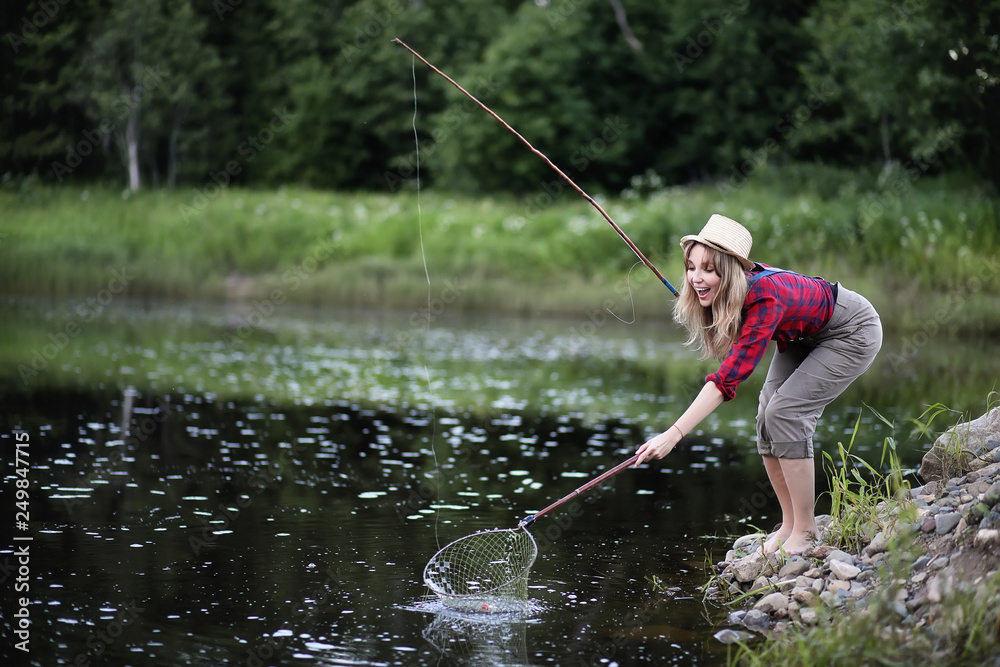 Girl by the river with a fishing rod Girl by the river with a fishing rod