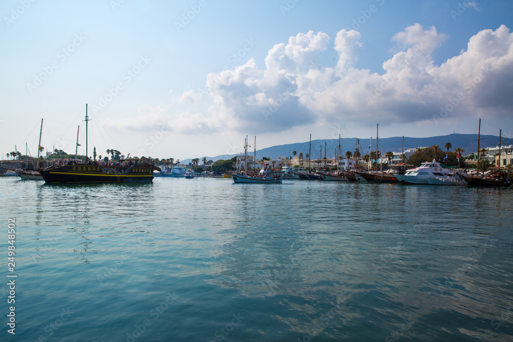 Beautiful view to Kos island port in Greece. Beautiful sky and a lot of ships in harbor. 