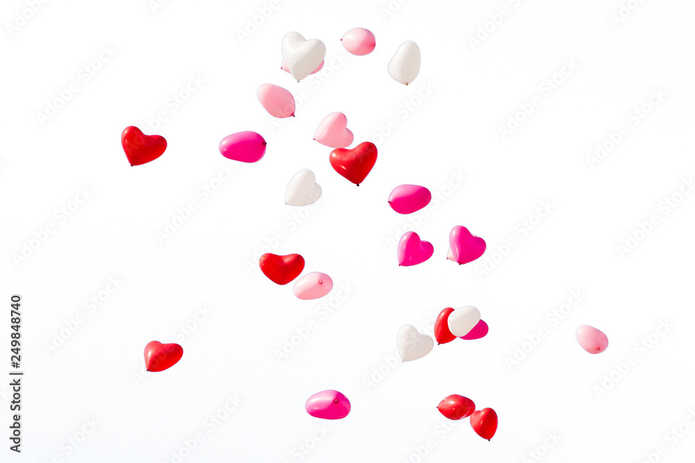 White, pink and red heart shaped balloons on white isolated background White, pink and red heart shaped balloons on white isolated background