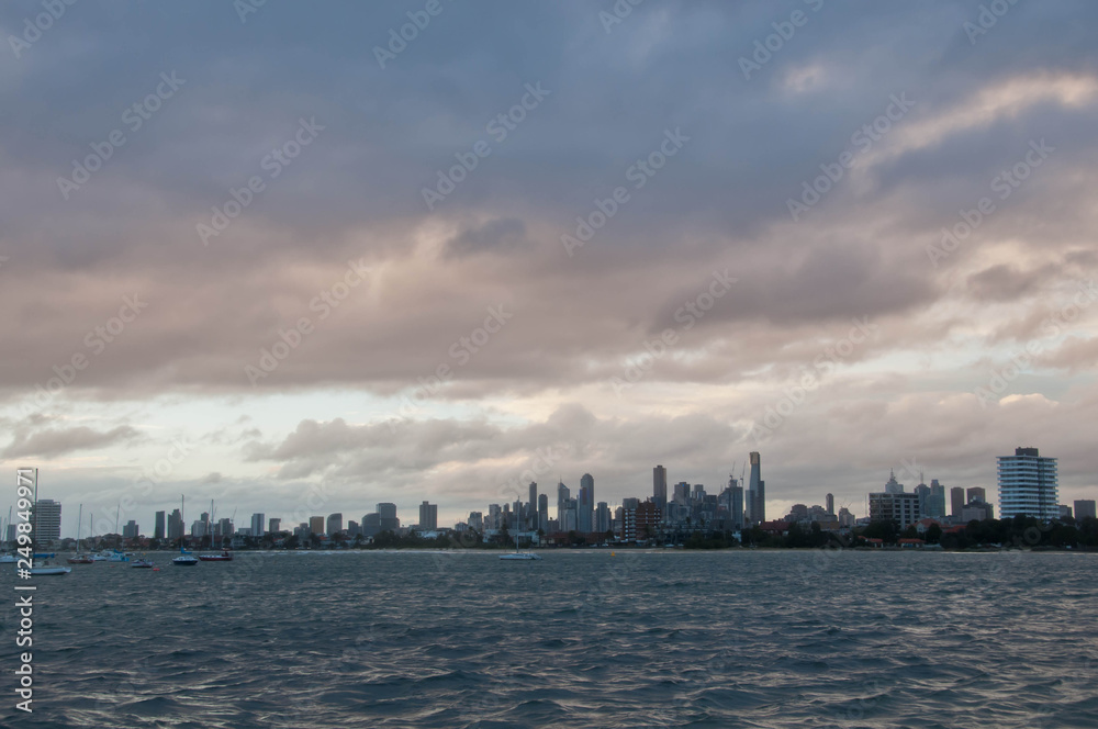 Wide angle evening scene of skyscrapers horizon with ocean and tall office and residential towers in Melbourne Australia