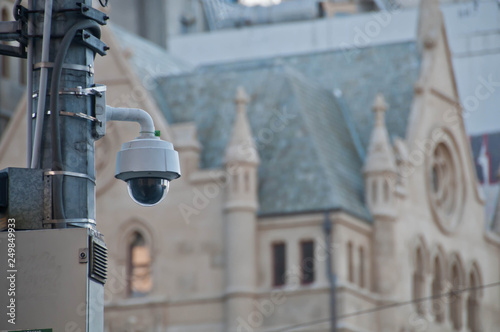 Surveillance CCTV street outdoor camera watching pedestrian near