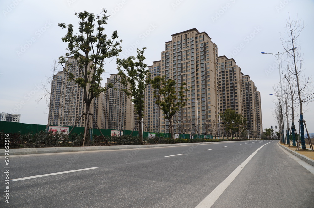 A group of tall buildings on the side of the road