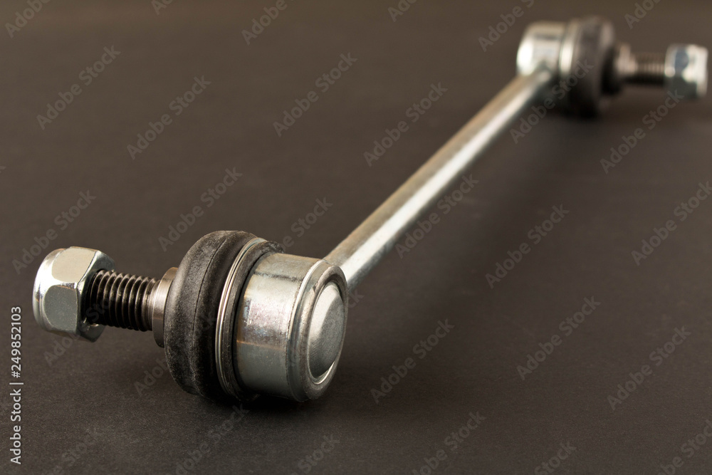 New car parts. Stabilizer link. Isolated on black background. New car parts. Stabilizer link. Isolated on black background.