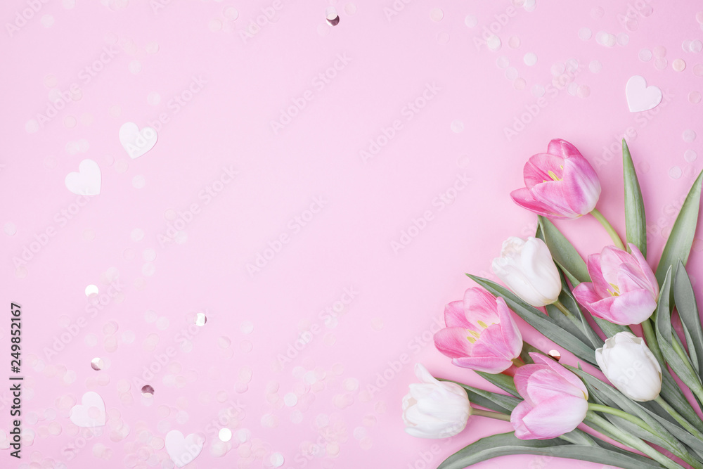 Spring tulip flowers on pastel pink background top view. Greeting card for International Women Day, Mother day. Flat lay. - obrazy, fototapety, plakaty 