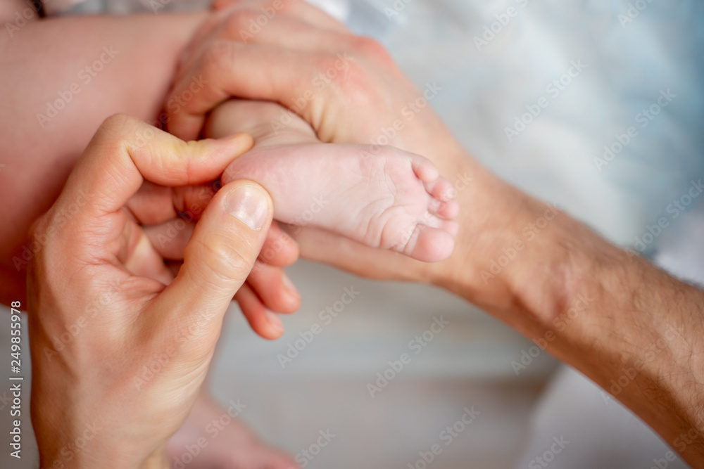 Male masseur doing massage for small child's leg, lying on table. Male masseur doing massage for small child's leg, lying on table.