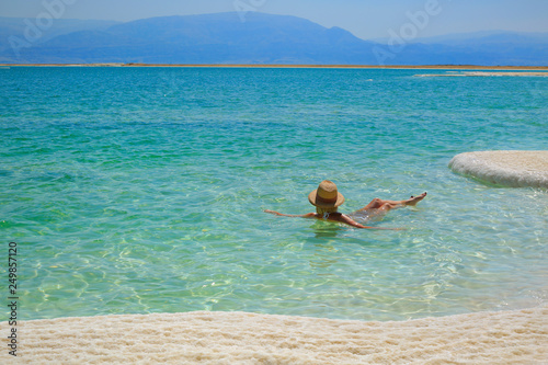 Girl relaxing in the water of Dead Sea photo